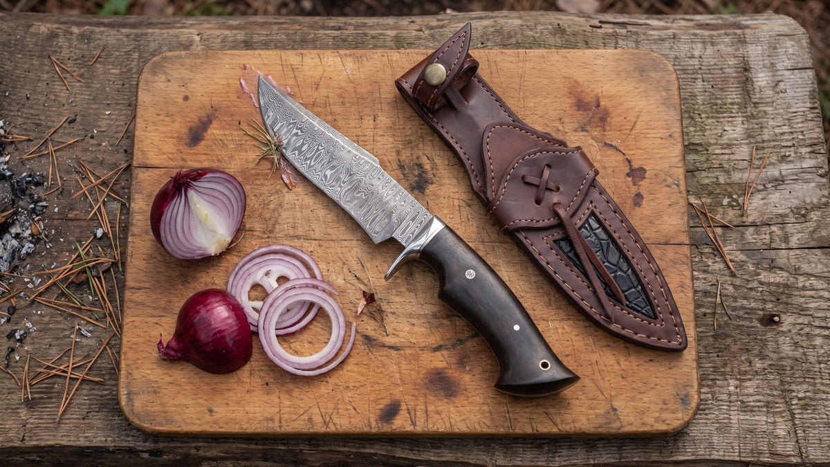 Leopard Hunter Damascus knife on a camp cutting board beside sliced red onion and its leather sheath