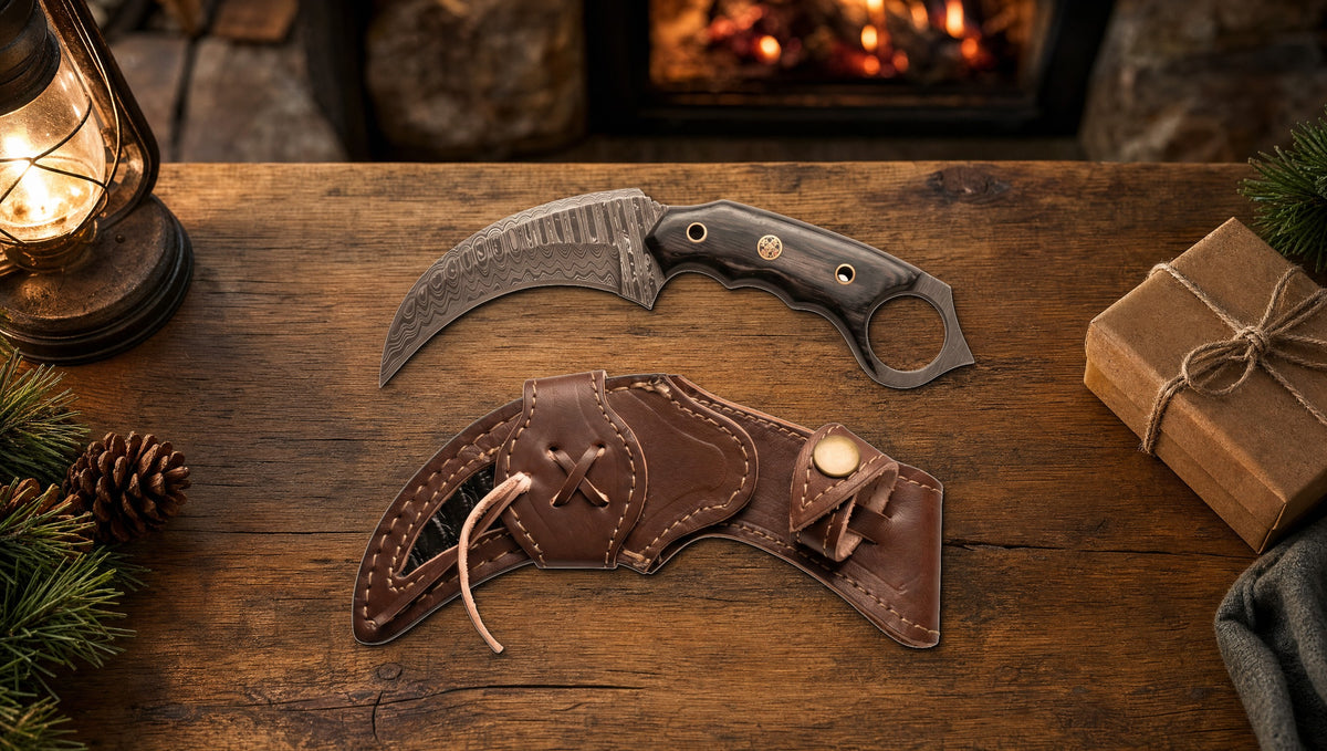 Karambit Desert Fox Damascus knife and its curved leather sheath beside a wrapped gift on a cabin table