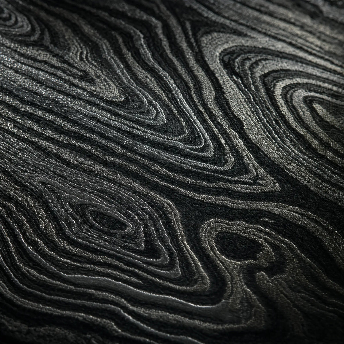 Macro of pattern-welded Damascus steel, light and dark layers filling the frame