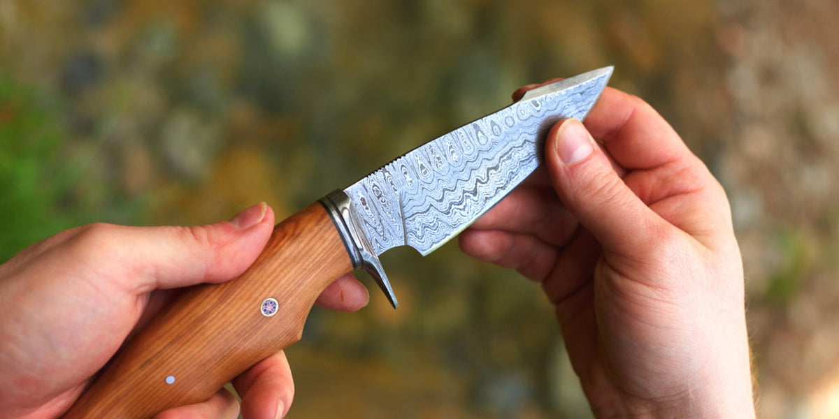 A fixed blade knife beside its leather sheath