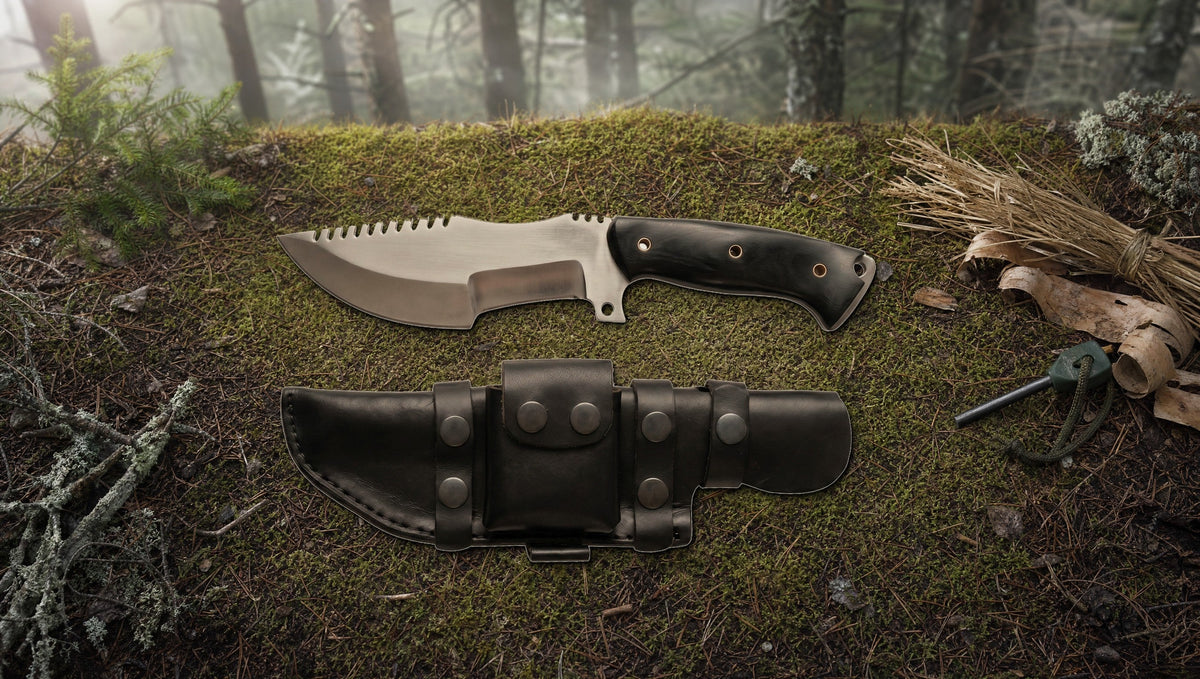 Tracker D2 steel knife with a black Micarta handle on the forest floor beside a ferro rod and tinder