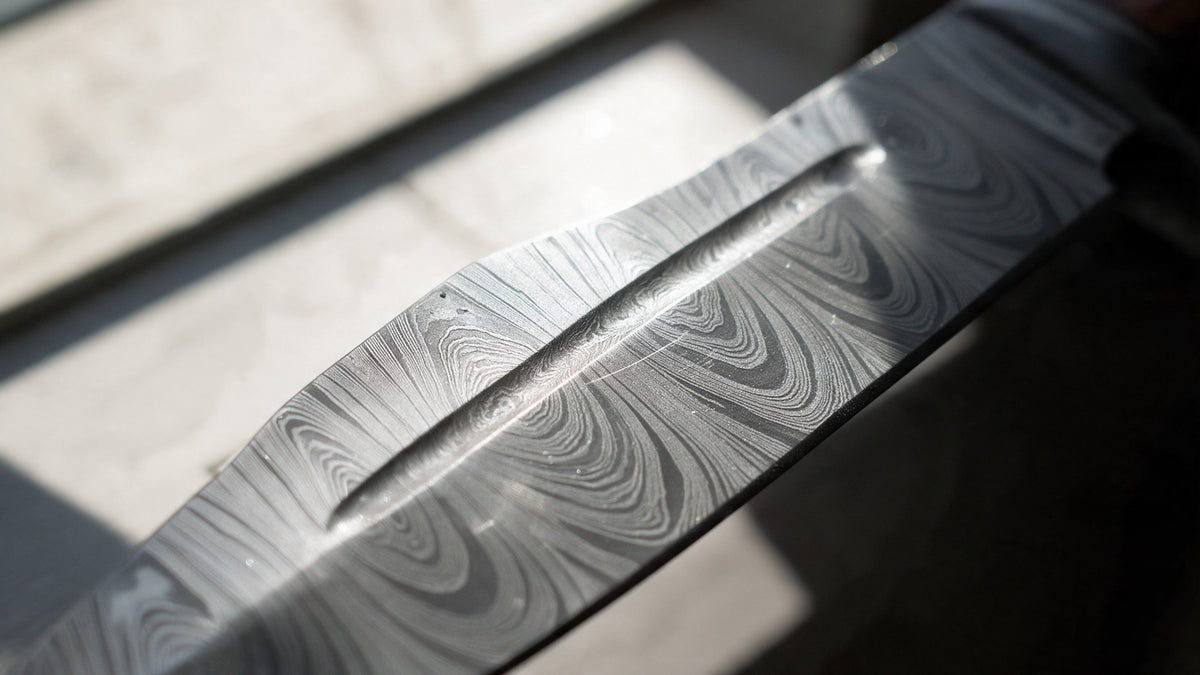 Close up of the layered Damascus steel pattern on a Beast Hunter blade