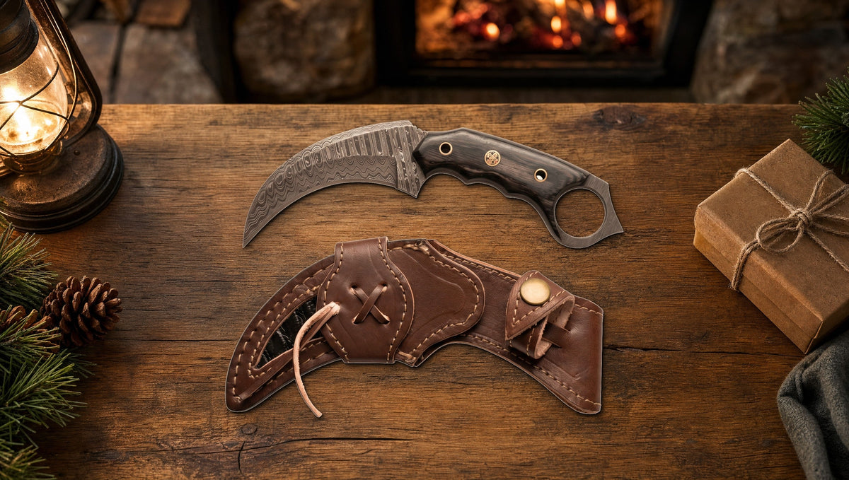 Karambit Desert Fox Damascus knife and its curved leather sheath beside a wrapped gift on a cabin table