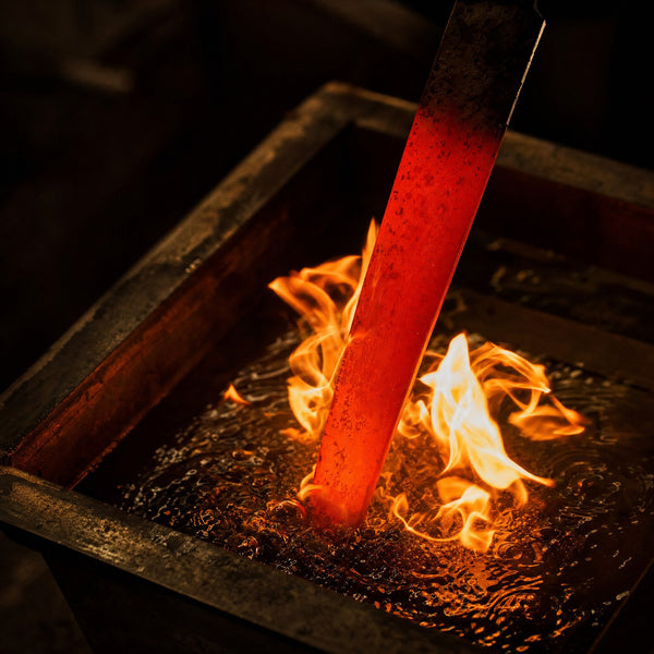 A red hot blade going into the quench oil